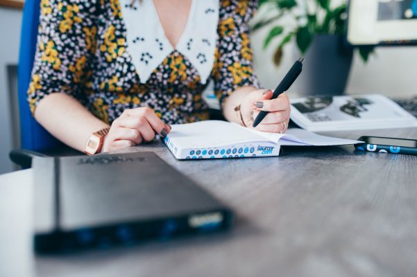 Writing in a branded notebook